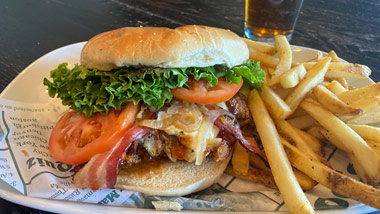 chicken bacon sandwich with fries and a beer