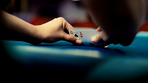 person looking at poker hand