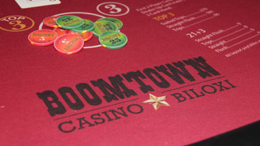 red velvet table with Boomtown casino Biloxi logo and gaming chips