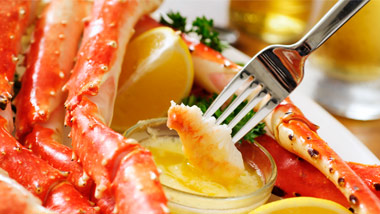 crab legs dipping in butter