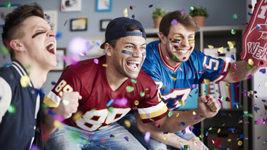 football fans celebrating in their living room